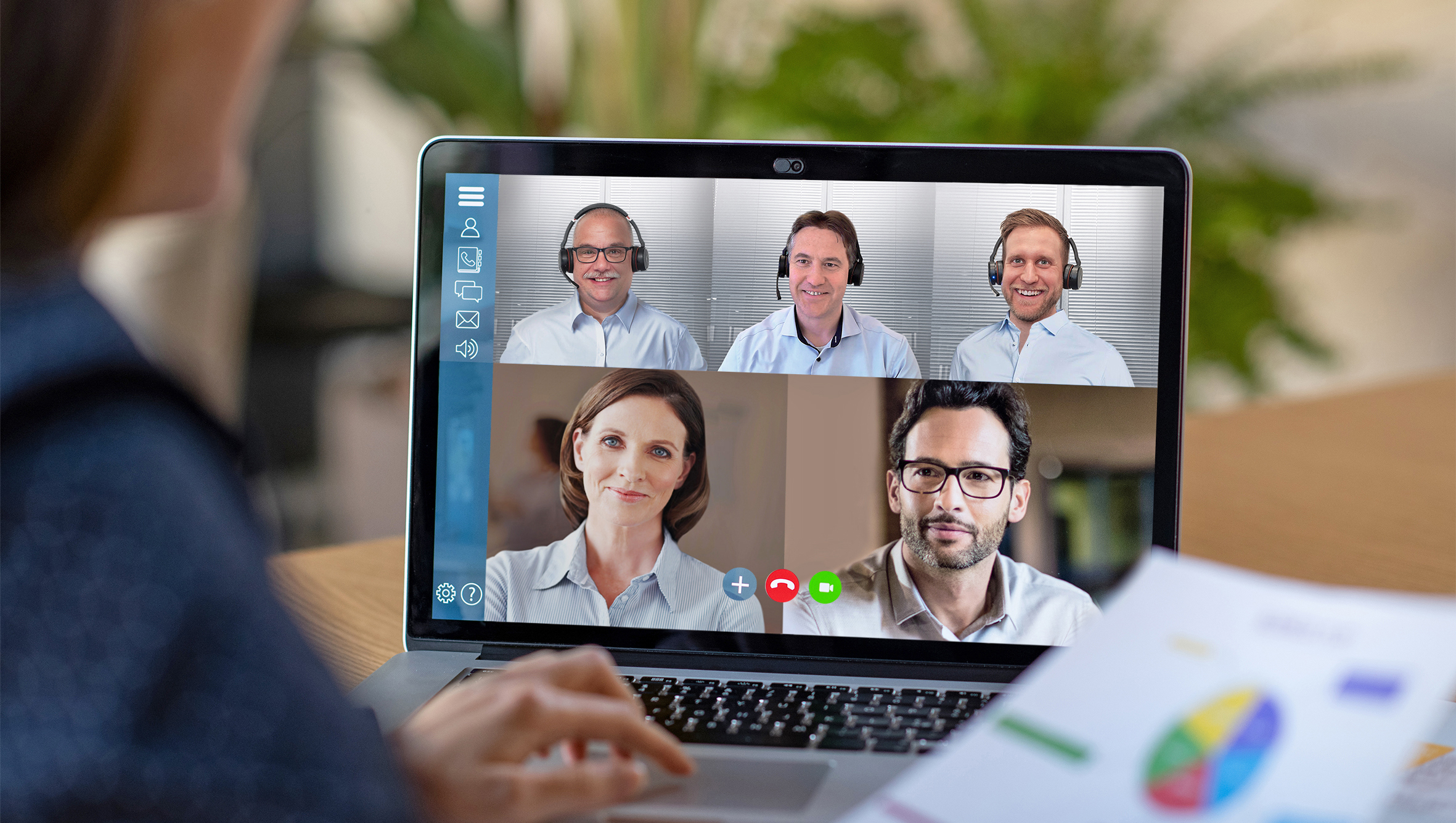 Laptop monitor shows multiple people in an online meeting